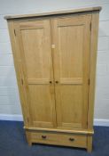A MODERN OAK DOUBLE DOOR WARDROBE, atop a base with a single drawer, width 113cm x depth 60cm x