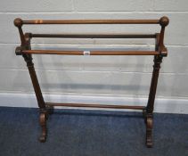 A VICTORIAN MAHOGANY TOWEL RAIL, with four rails, scrolled supports and legs, and tapered