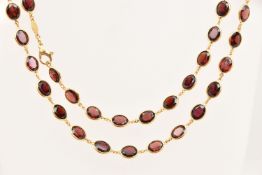 AN 18CT GOLD GARNET SPECTACLE SET NECKLACE, designed as oval cut garnets each in a collet setting,