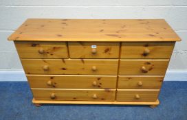 A MODERN PINE SIDEBOARD, fitted with nine assorted drawers, length 121cm x depth 39cm x height 75cm,