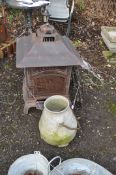 A MODERN STEEL PAGODA STYLE GARDEN LOG BURNER with mesh sides and flue roof height 82cm, a fire
