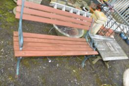 A MODERN CAST IRON ENDED GARDEN BENCH with slatted wood seat and back (feet have raisers welded to