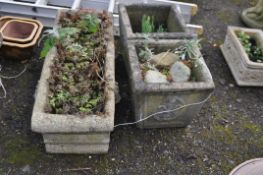 THREE CONCRETE GARDEN PLANTERS including one rectangular with lion mask bosses length 90cm and a