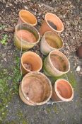 A COLLECTION OF EIGHT TERRACOTTA AND COLOURED GARDEN POTS the largest being 38cm high and stamped