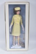A BOXED FRANKLIN MINT 'THE JACKIE DOLL', vinyl Jackie Onassis doll in yellow satin two piece