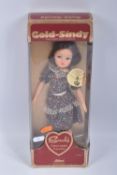 A BOXED SCHUCO GOLD-SINDY, No.14-4816, appears complete with both necklaces and stand and in very