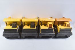 FOUR MIGHTY TONKA TOYS DUMPER TRUCKS, all in playworn condition with paint loss, surface rusting,