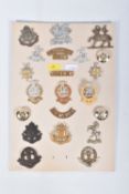 A CARD WITH TWENTY ONE ITEM SUCH AS COLLAR INSIGNIA, CAP BADGES, SHOULDER TITLES, BUTTONS to name