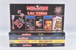 FOUR BOXED US CITY USAOPOLY MONOPOLY SETS, to include a sealed 2001 New York City, a unsealed 1998