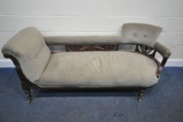 AN EDWARDIAN MAHOGANY FRAMED SOFA, one end scrolled, the other mimicking a chair, scrolled and