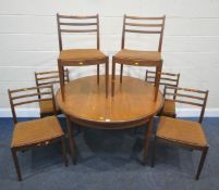 G PLAN, A MID CENTURY TEAK EXTENDING DINING TABLE, raised on cylindrical tapered legs, diameter