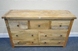 A MODERN HARDWOOD SIDEBOARD, fitted with seven assorted drawers, length 141cm x depth 45cm x