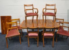 A 20TH CENTURY YEW WOOD TWIN PEDESTAL TILT TOP DINING TABLE, with one additional leaf, length