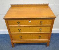 A 20TH CENTURY OAK CHEST OF THREE DRAWERS, raised on square legs, with castors, width 87cm x depth