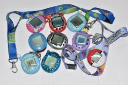 A BOX OF TAMAGOTCHIS AND A POKE WALKER, four of the Tamagotchis and the Poke Walker are in working
