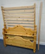 A MODERN PINE 4FT6 BEDSTEAD, with side rails, slats, bolts, and a central support, condition report: