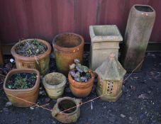 A SELECTION OF TERRACOTTA GARDEN POTS, to include a tall slim planter, height 75cm, a chimney pot,