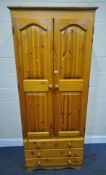 A MODERN PINE DOUBLE DOOR WARDROBE, with three drawers, width 83cm x depth 54cm x height 200cm,