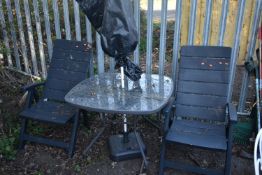 A METAL SQUARE GARDEN TABLE, two folding plastic chairs and a parasol (4)
