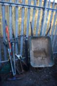 A SELECTION OF GARDEN TOOLS, inclining a metal wheel barrow, spades, shovels, axe, brushes, rakes