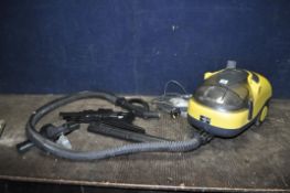 A DOMOTEC STEAM VACUUM, with various heads and pipework (PAT pass and working)