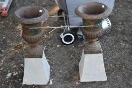 A PAIR OF SMALL CAST IRON CAMPAGNA GARDEN URNS, on a later concrete splayed support, overall
