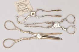 TWO PAIRS OF SUGAR TONGS AND A PAIR OF GRAPE SCISSORS, the first with shell shape nibs, engraved pig