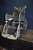 A VINTAGE NEWTON FOLDING WHEELCHAIR with two footrests but seat deteriorating and tyres flat