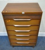 WHITE AND NEWTON, A MID-CENTURY TEAK CHEST OF SEVEN DRAWERS, the top drawer with a reeded front,