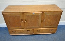 LUCIAN ERCOLANI, AN ERCOL MID-CENTURY ELM WINDSOR SIDEBOARD, fitted with three cupboard doors, the