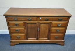 AN EARLY 20TH CENTURY SIDEBOARD, fitted with eight assorted drawers, and double cupboard doors, on