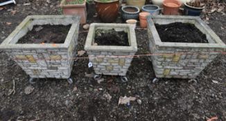 A SET OF THREE BRICK EFFECT SQUARE TAPERED PLANTERS, on metal legs, largest pots 40cm squared x