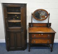 A 20TH CENTURY OAK DRESSING CHEST, with an oval bevelled edge mirror, atop a base with two