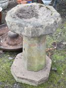 A SANDSTONE OCTAGONAL BIRD BATH, on a separate column support and plinth, diameter 51cm x height