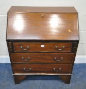 AN EARLY 20TH CENTURY MAHOGANY AND CROSS BANDED BUREAU, the fall front door enclosing a fitted