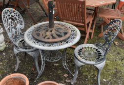 AN OVERPAINTED CAST ALUMINIUM GARDEN TABLE, diameter 65cm x height 62cm, two chairs and a cast
