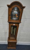 A LATE 20TH CENTURY GRANDDAUGHTER CLOCK, the arched glass door enclosing a 6.5 brass and silvered