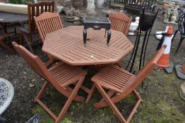 A TEAK OCTAGONAL FOLDING GARDEN TABLE, diameter 112cm x height 72cm, and four folding chairs,