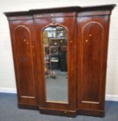 A VICTORIAN MAHOGANY TRIPLE DOOR BREAK FRONT COMPACTUM WARDROBE, the central mirrored door enclosing