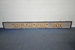 A LARGE RECTANGULAR PUB SIGN READING GREYHOUND INN, with a black painted frame, 3D gilt lettering