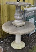 A WEATHERED COMPOSITE CIRCULAR GARDEN TABLE, on a reeded column and octagonal support, diameter 92cm