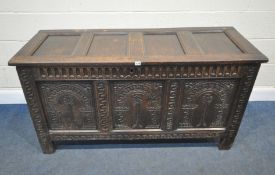 A GEORGIAN OAK COFFER, with repeating geometric patterns, carved panels to the front and sides,