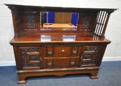 AN EARLY 20TH CENTURY WALNUT MIRROR BACK SIDEBOARD, the raised back with a central bevelled mirror