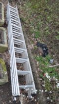 AN ABRU ALUMINIUM TRIPLE EXTENSION LADDER, with eleven rungs to each 300cm length, full extension