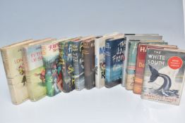A BOX OF TWELVE MOSTLY FIRST EDITION ACTION AND ADVENTURE HARDBACK NOVELS to include three Hammond