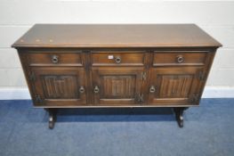 JAYCEE, A 20TH CENTURY OAK SIDEBOARD, fitted with three drawers, over three linenfold cupboard
