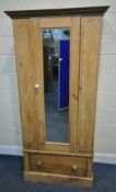 A 19TH CENTURY PINE WARDROBE, with a single mirror door, over a deep drawer, width 92cm x depth 49cm