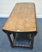 A GEORGIAN OAK GATE LEG TABLE, with a single drawer to each end, raised on bobbin turned legs,