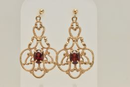 A PAIR OF 9CT GOLD GARNET SET DROP EARRINGS, each of an open work scrolling design set with a