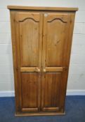 A MODERN PINE DOUBLE DOOR WARDROBE, width 96cm x depth 52cm x height 191cm, condition report: marks,